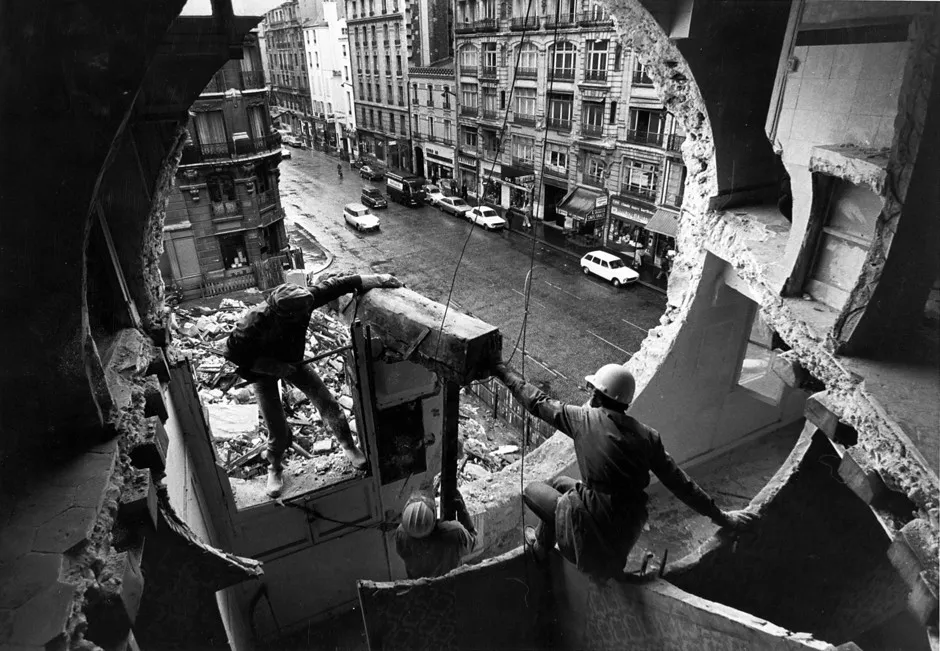 Gordon Matta-Clark and Gerry Hovagimyan working on Conical Intersect, 1975.