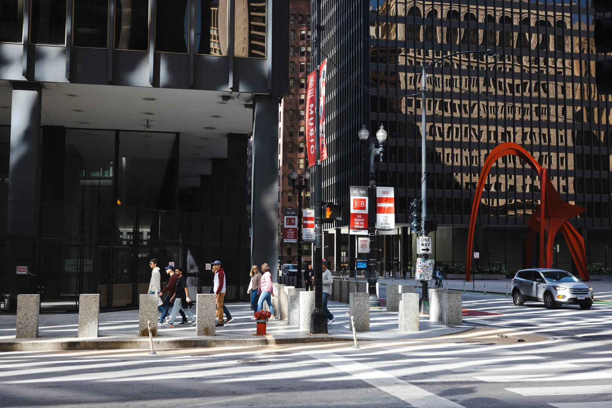 Pedestrians walk past security fencing around the Dirksen Federal Building in Chicago.