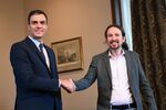 Pedro Sanchez, left, and Pablo Iglesias shake hands during a press conference in Madrid on Nov. 12.
