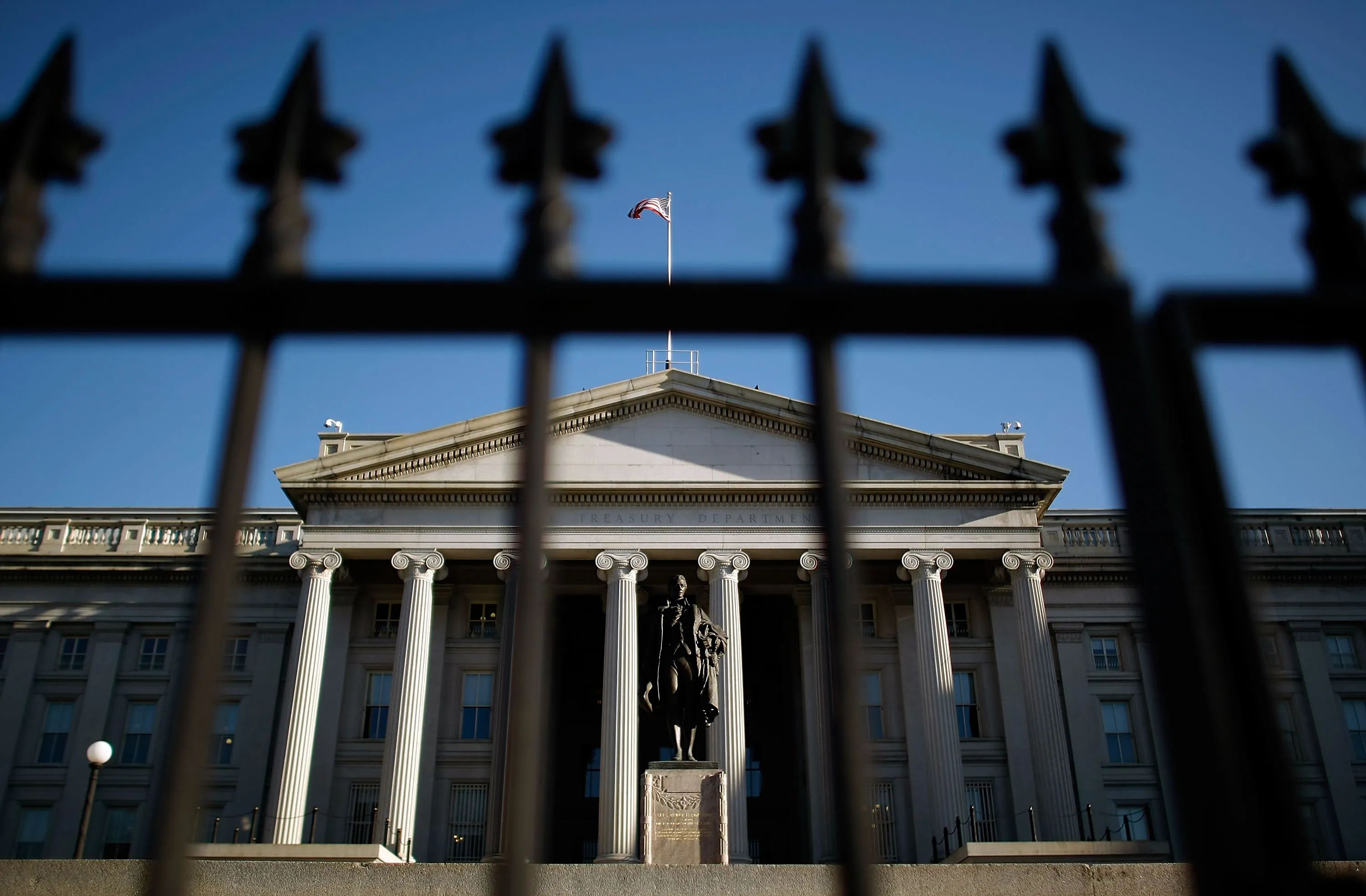 A statue of the first Secretary of the Treasury Alexander Hamilton in front of the US Treasury Department building.