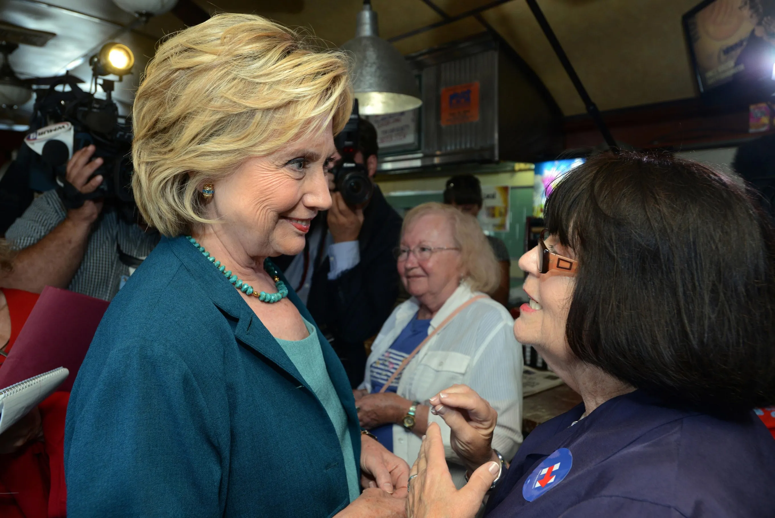LACONIA, NH - SEPTEMBER 17: Democratic Presidential candidate Hillary Clinton speaks with Paula Trombi at The Union Diner September 17, 2015 in Laconia, New Hampshire. Clinton spent the day campaigning and spoke at on substance abuse. *** Local Caption *** Hillary Clinton;Paula Trombi
