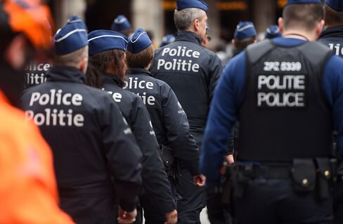 Police walk together in Brussels on March 23, 2016, a day after blasts hit the Belgian capital.