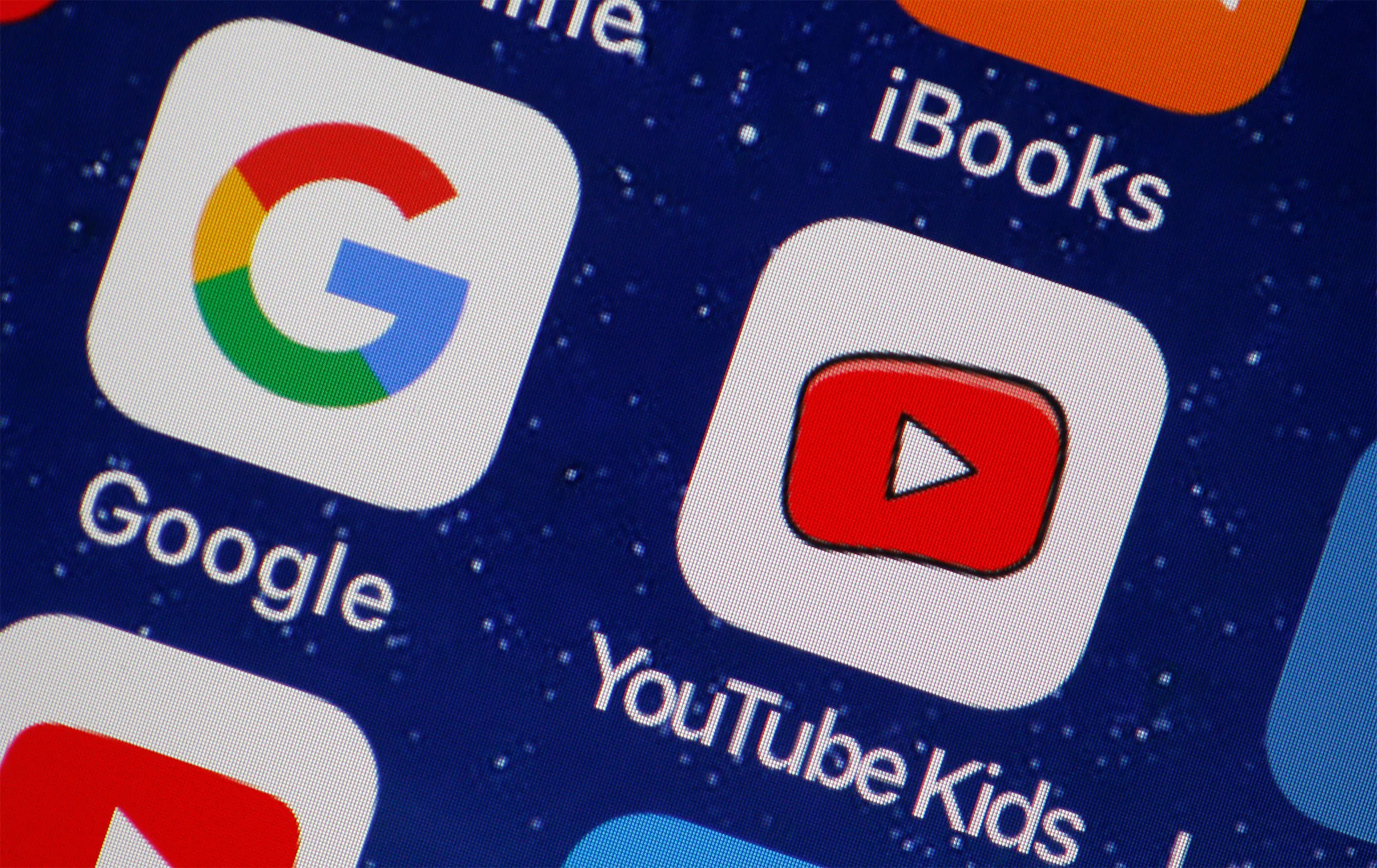 PARIS, FRANCE - APRIL 10: In this photo illustration, the logo of the Google and You Tube Kids applications are displayed on the screen of an Apple iPhone on April 10, 2018 in Paris, France. Twenty-three US digital rights and child protection organizations have accused YouTube and its parent company Google of collecting personal data about children and using it to target advertisements, a complaint has been filed with the FTC, the US trade regulator. (Photo by Chesnot/Getty Images)