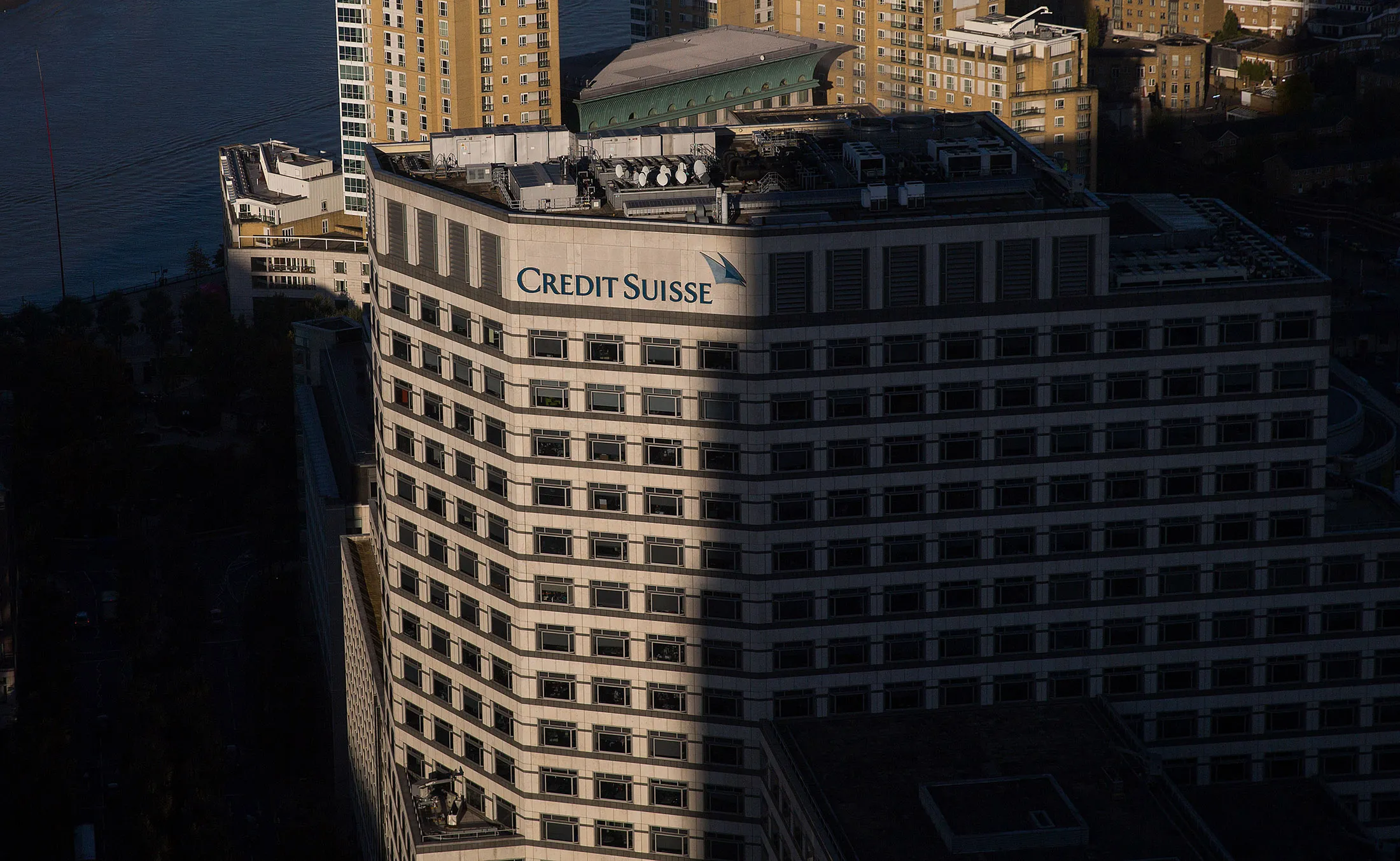 A Credit Suisse logo sits on their offices in London.
