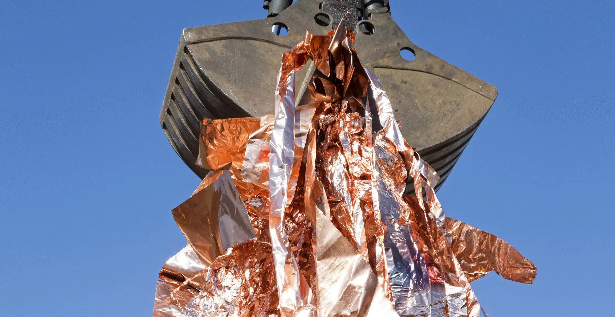 An excavator grabs copper scrap for recycling at the Aurubis AG metals plant in Hamburg, Germany.