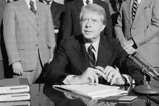 President Jimmy Carter talks to onlookers before signing his economic, tax, and budget messages at a ceremony at the White House in Washington on Jan. 20, 1978