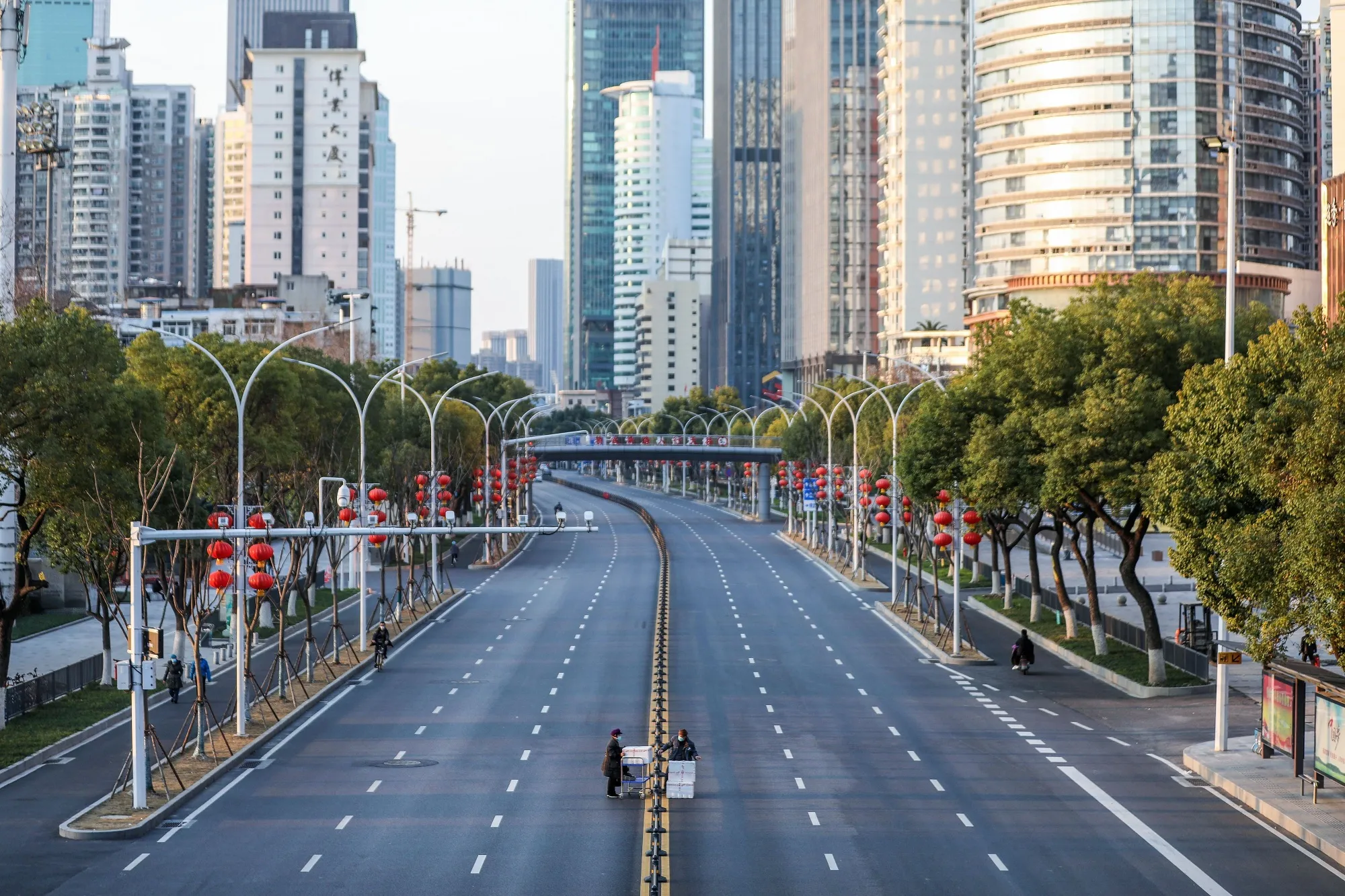 Pedestrians cross an empty road in Wuhan on Feb. 20.
