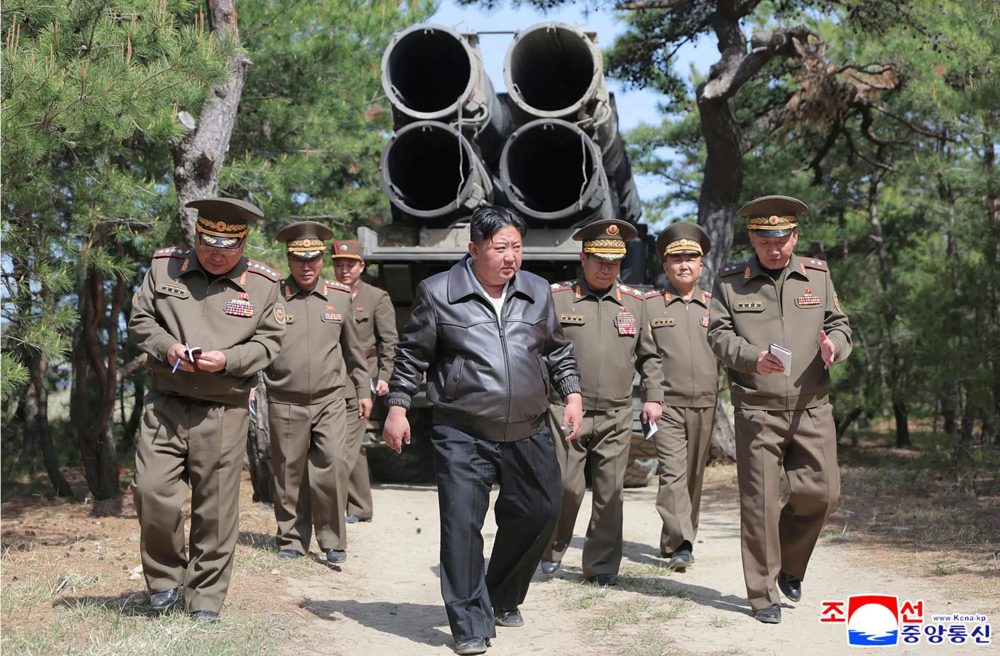 In this photo provided by the North Korean government, Kim Jong Un, center, supervises a drill of long-range artillery and missile systems at North Korea’s eastern coast on May 8.