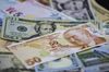 Turkish lira and dollar banknotes sit in this arranged photo at a currency exchange bureau in Istanbul, Turkey, on Monday, June 25, 2018. The gains in Turkeys lira that followed Recep Tayyip Erdoganselection victory fizzled out as investors worried that the presidents sweeping new powers may stymie efforts to rein in inflation and the widening current-account deficit.
