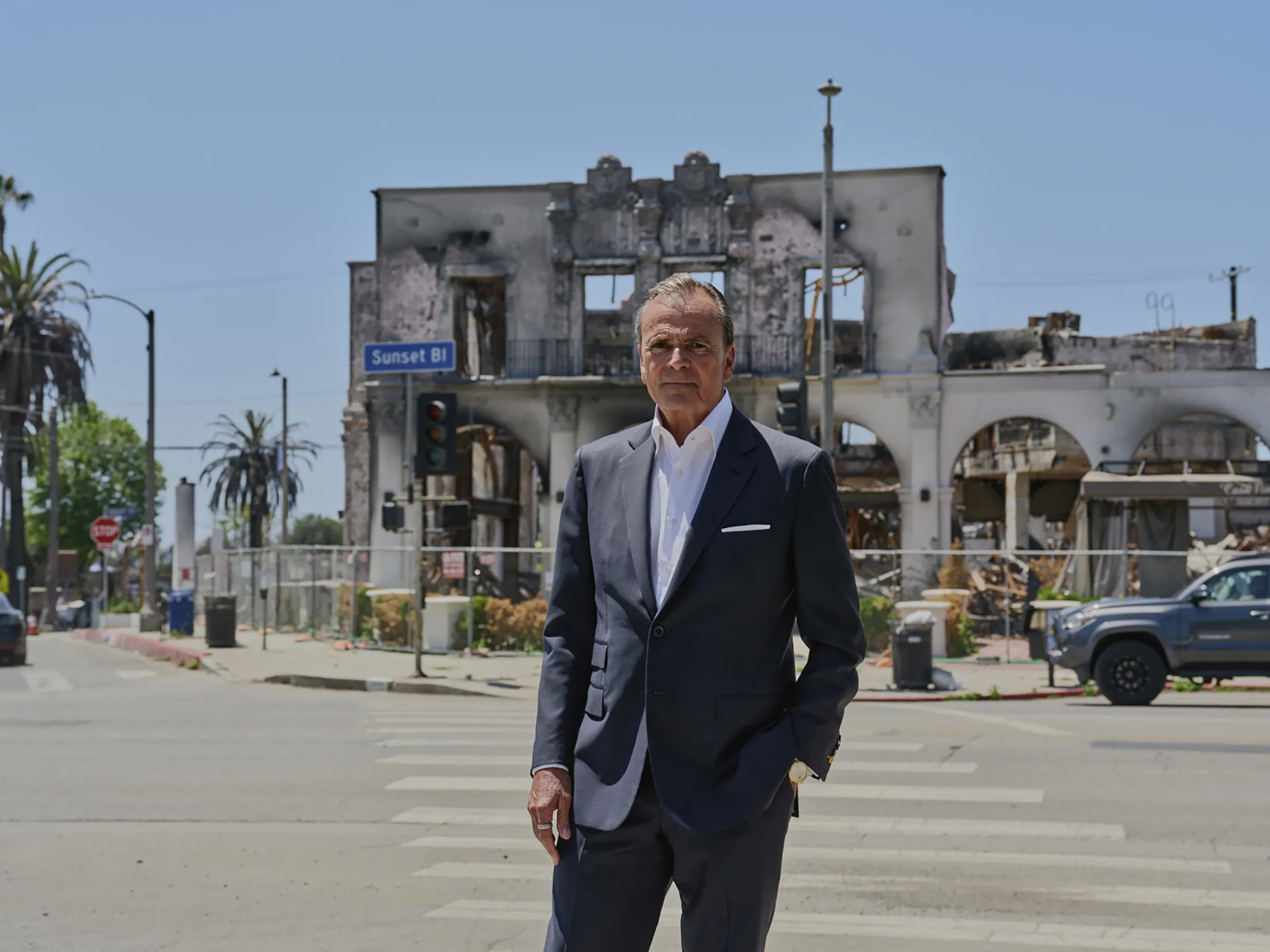 Caruso outside a building destroyed by fire, across the street from his Palisades Village mall in Los Angeles.