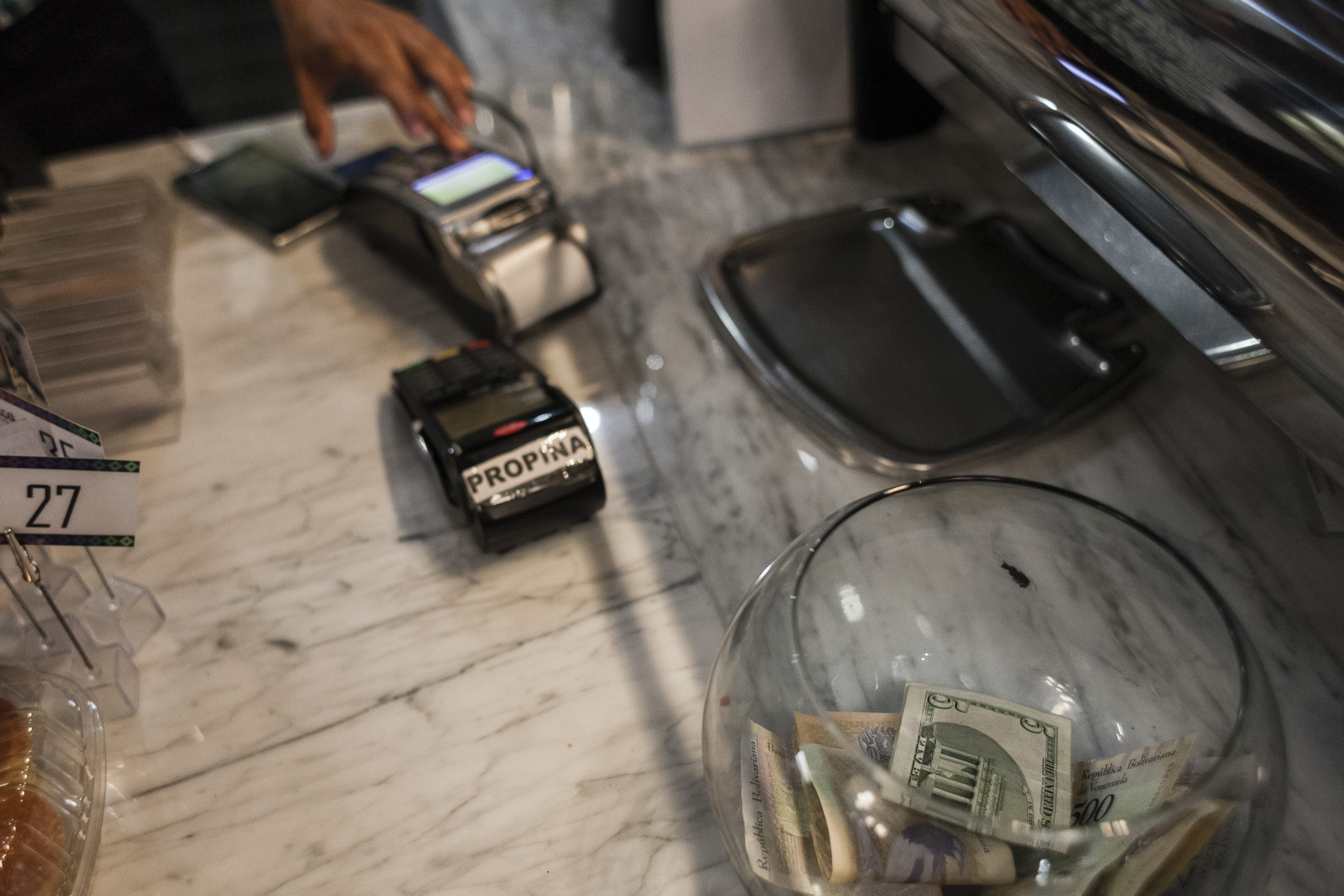 A tip jar filled with U.S. dollars and Venezuelan bolivares at a coffee shop in Caracas&nbsp;on&nbsp;June 5, 2019.&nbsp;