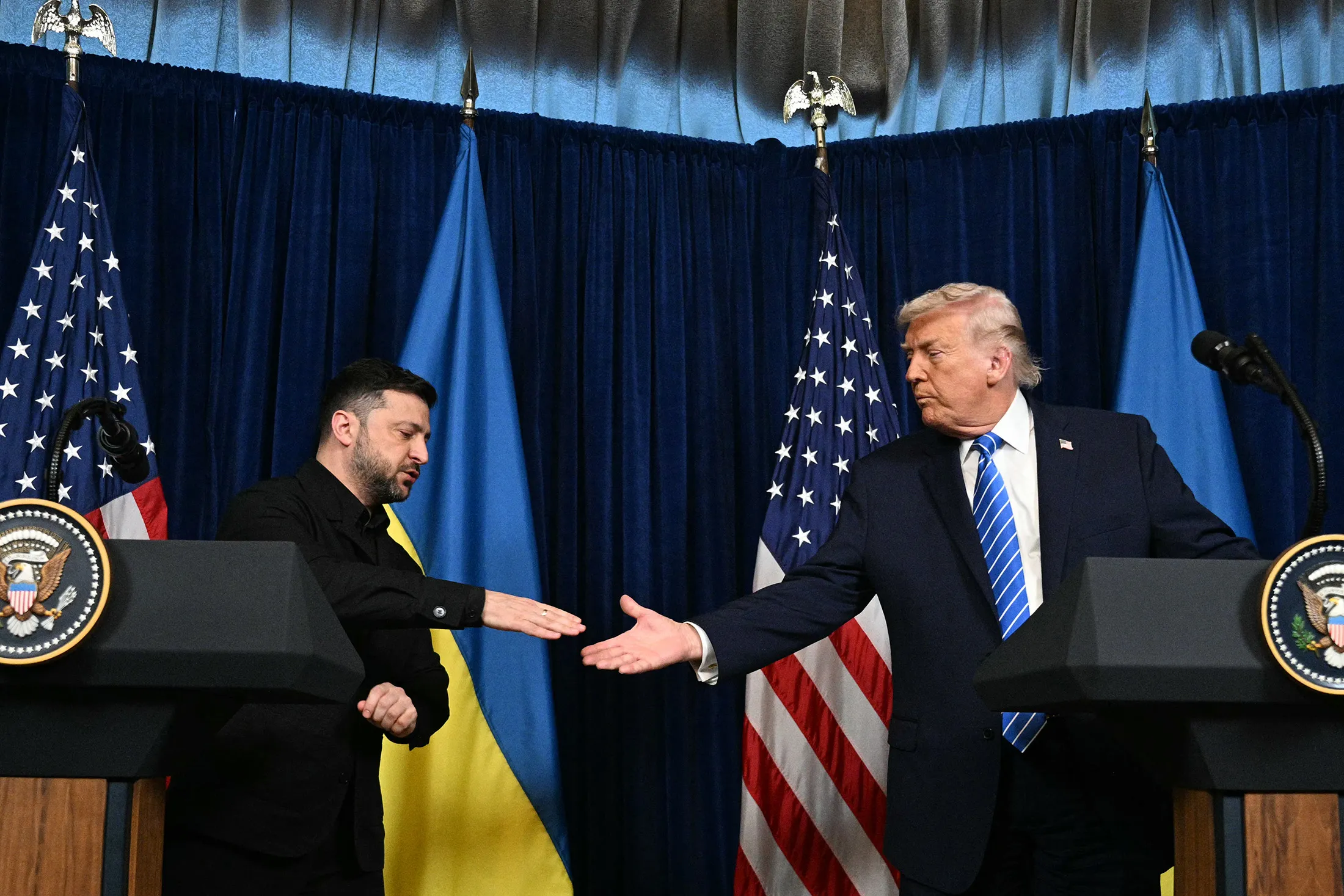 Presidents Donald Trump, right,&nbsp;and Volodymyr Zelenskiy shake hands during a press conference following talks at Mar-a-Lago in Palm Beach, Florida, on Dec. 28.