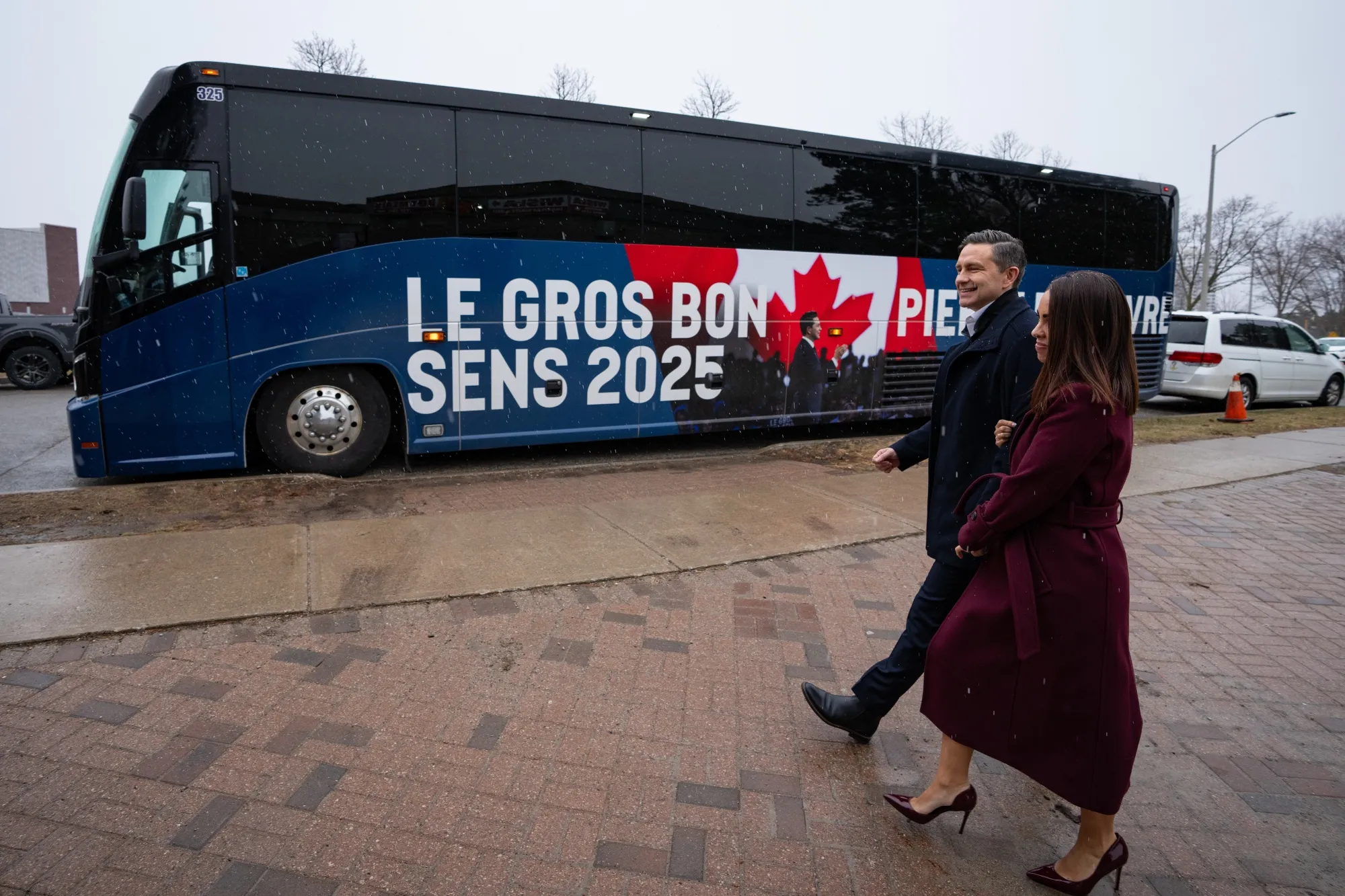 Pierre Poilievre, leader of Canada's Conservative Party, left, and wife Anaida walk back to their bus after a campaign event at Wisla Delicatssen Polish Deli in Mississauga, Ontario&nbsp;on Monday.
