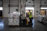 A worker uses a reach truck to move pallets of goods at an XPO Logistics Inc. distribution hub in Barcelona.