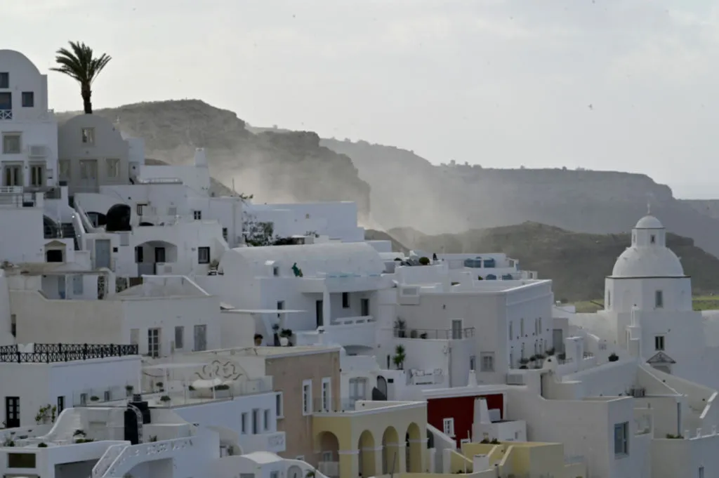 Dust from landslide caused by earthquake rises behind the town of Fira, Santorini.&nbsp;