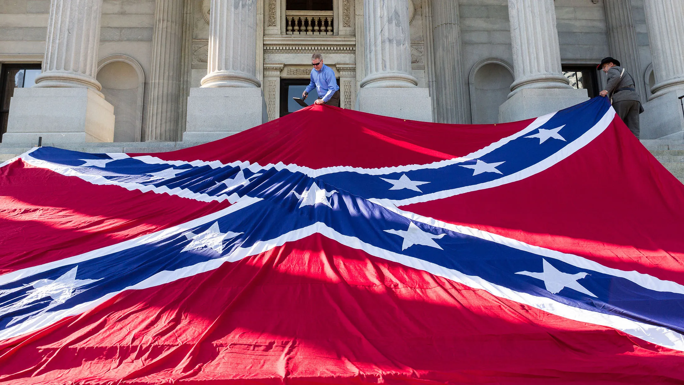 Confederate re-enactors position a gigantic Confederate flag on the steps of the South Carolina State Capitol building on May 2, 2015 in Columbia, South Carolina.
