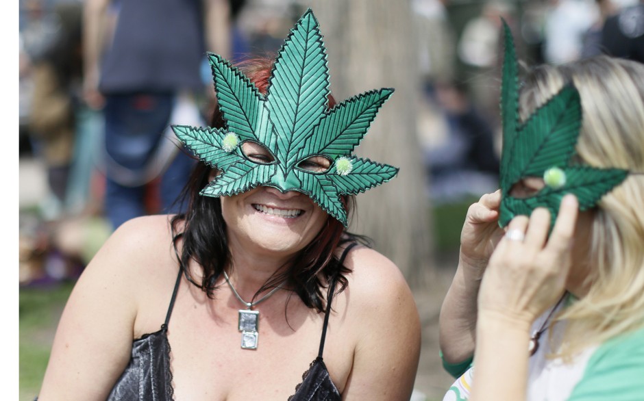 Women wearing marijuana leaf masks at the 4/20 marijuana holiday in Civic Center Park in downtown Denver, Colorado. 