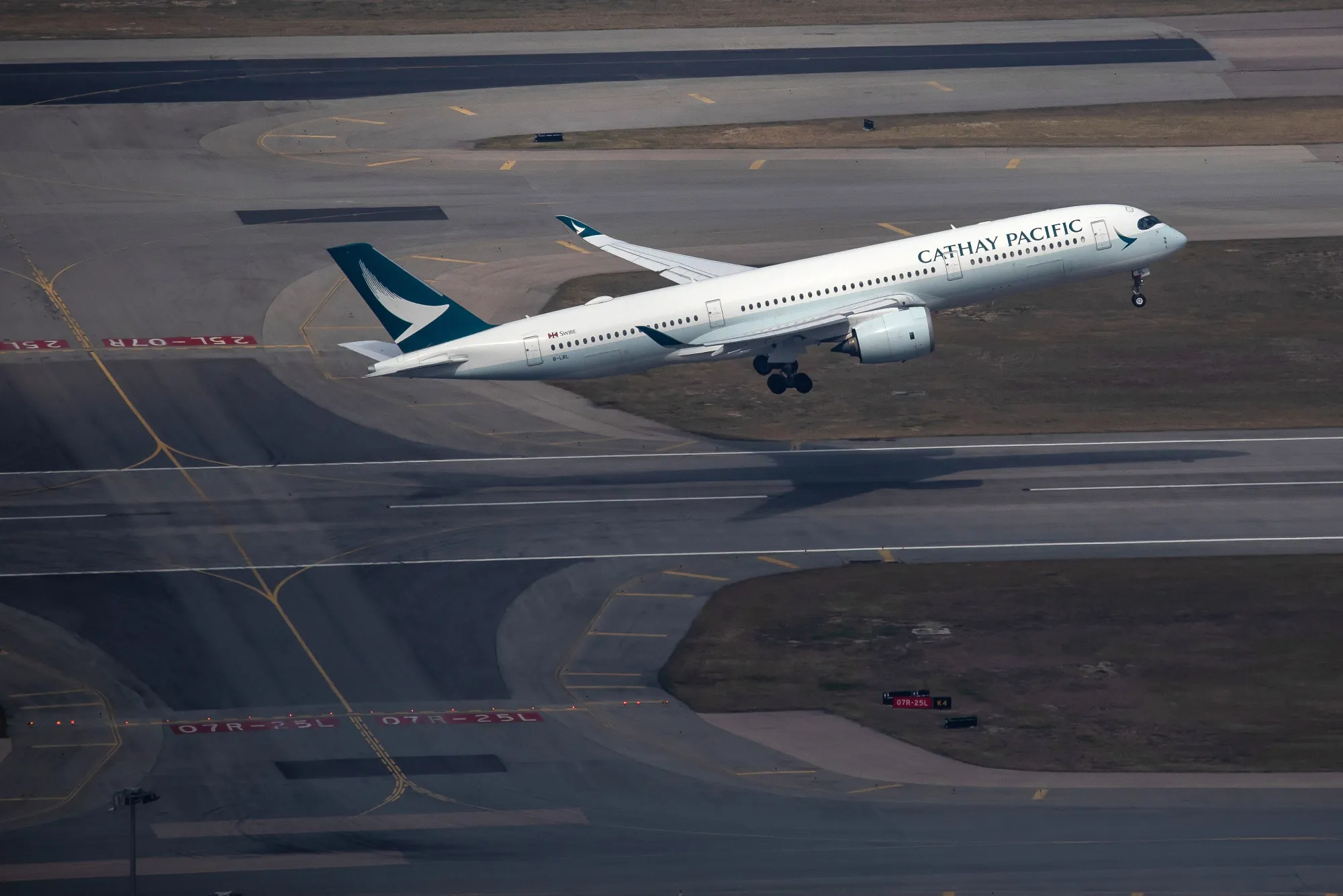 An aircraft operated by Cathay Pacific Airways Ltd. takes off.&nbsp;