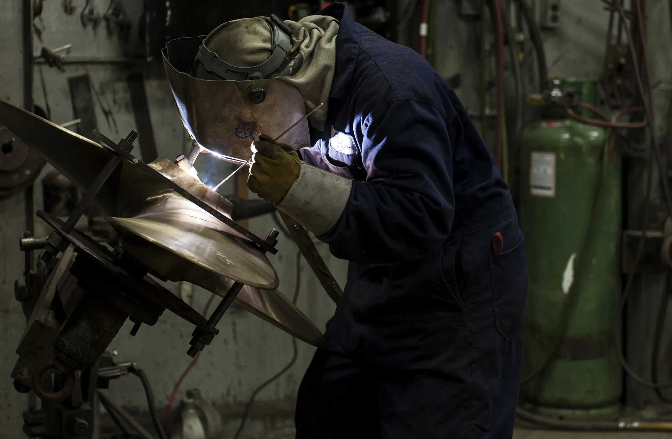 A worker welds a propeller core at a facility in North Vancouver, British Columbia, Canada.
