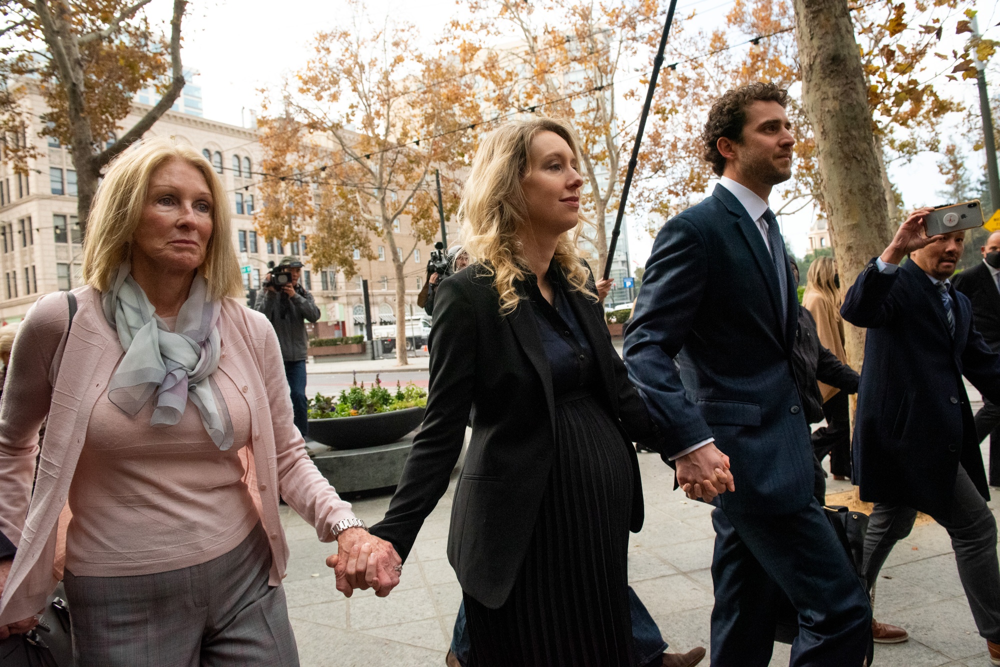 Elizabeth Holmes, founder of Theranos Inc., center, arrives at federal court with her mother Noel Holmes, left, and partner Billy Evans in San Jose, California, US, for her sentencing on Nov. 18, 2022. 