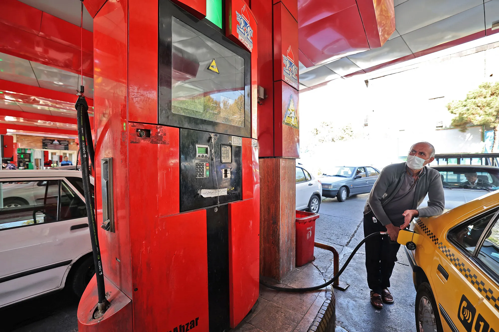 A man fills his car with petrol at a gas station in&nbsp;Tehran, Oct.&nbsp;27.