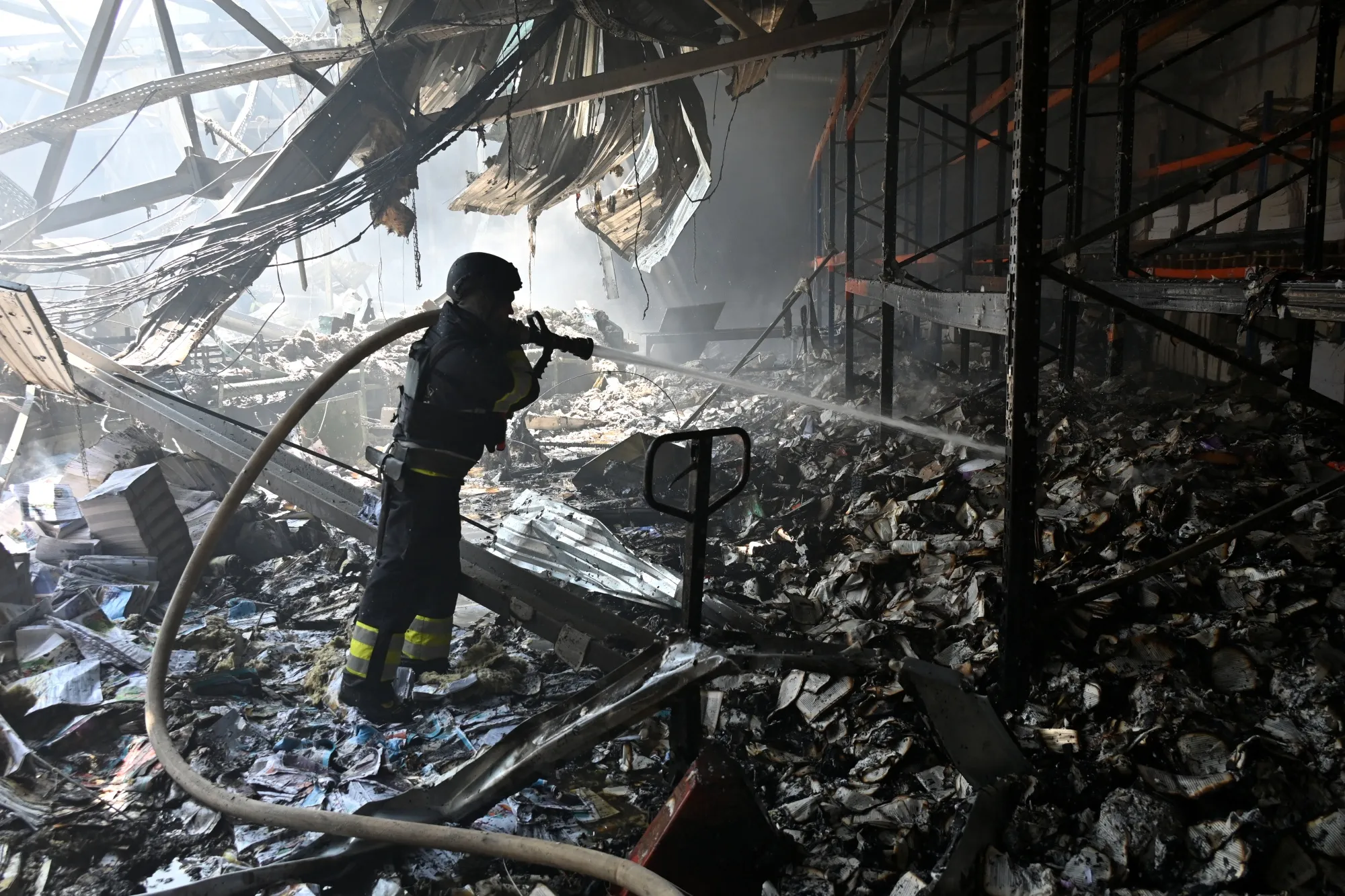 A Ukrainian rescuer works at the site of a missile attack in Kharkiv on May 23.