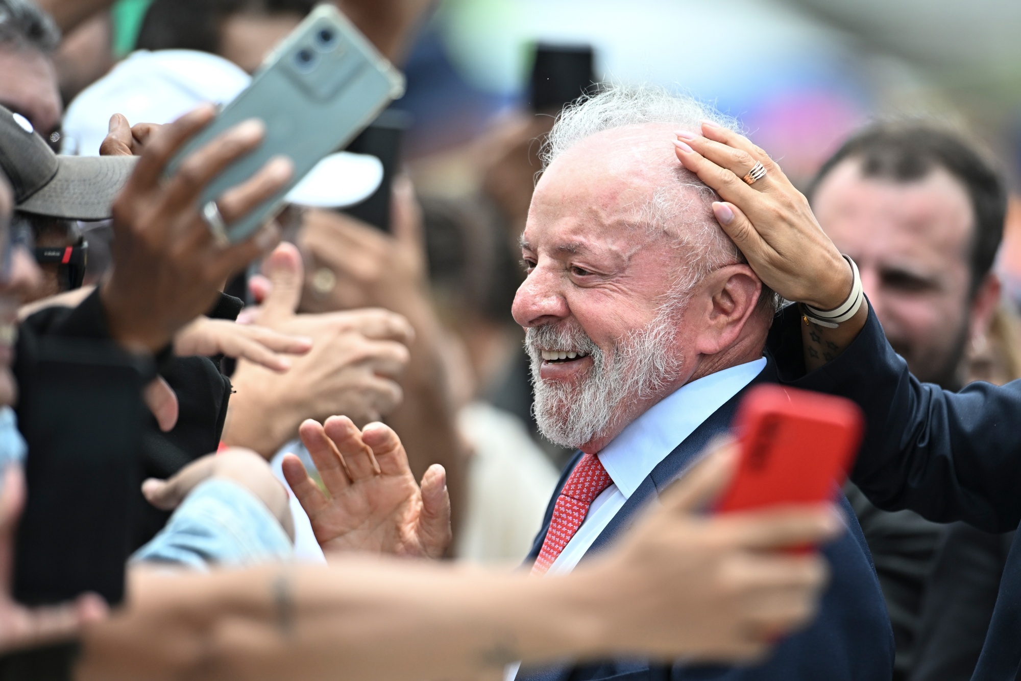 Luiz Inacio Lula da Silva, Brazil's president, greets supporters during a ceremony to commemorate three years since an attempted coup, at Planalto Palace in Brasilia, Brazil, on Thursday, Jan. 8, 2026. Lula vetoed a bill that sought to reduce the prison term of Jair Bolsonaro, the former president who is serving a 27-year sentence for plotting a coup following his 2022 election defeat. Photographer: Ton Molina/Bloomberg
