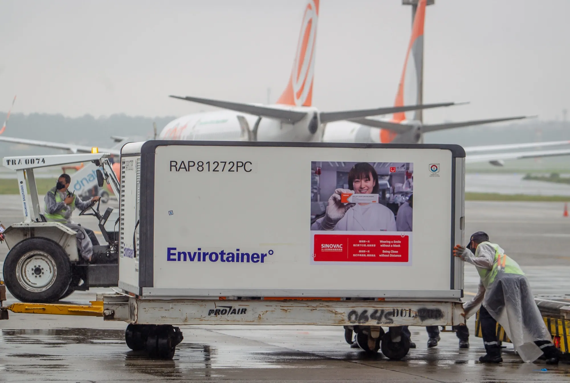 Workers unload a refrigerated container carrying Sinovac Biotech Ltd. coronavirus vaccines at Guarulhos International Airport in Sao Paulo on Nov. 19.