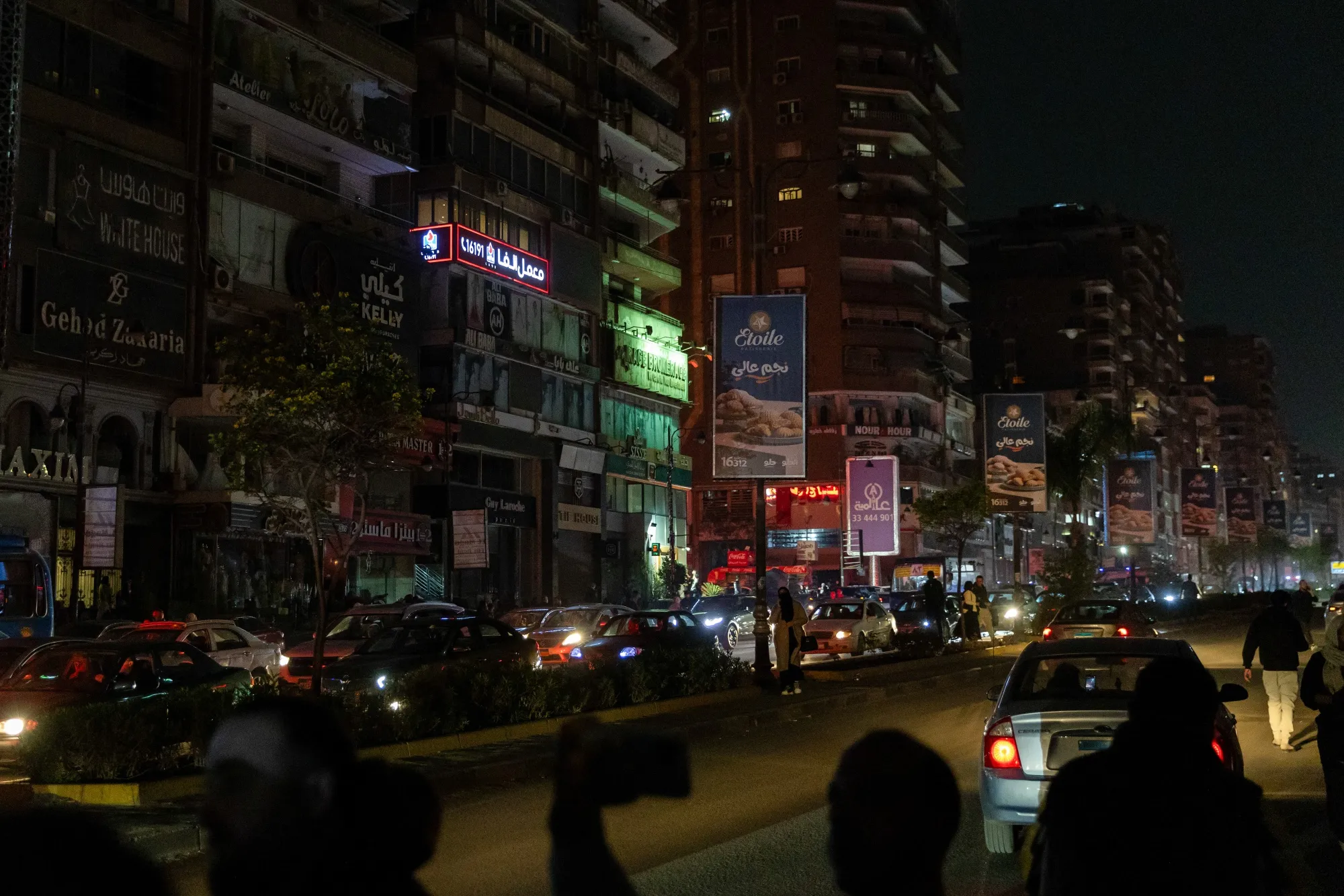 Reduced lighting and stores closing early to conserve energy, in Cairo, in March.