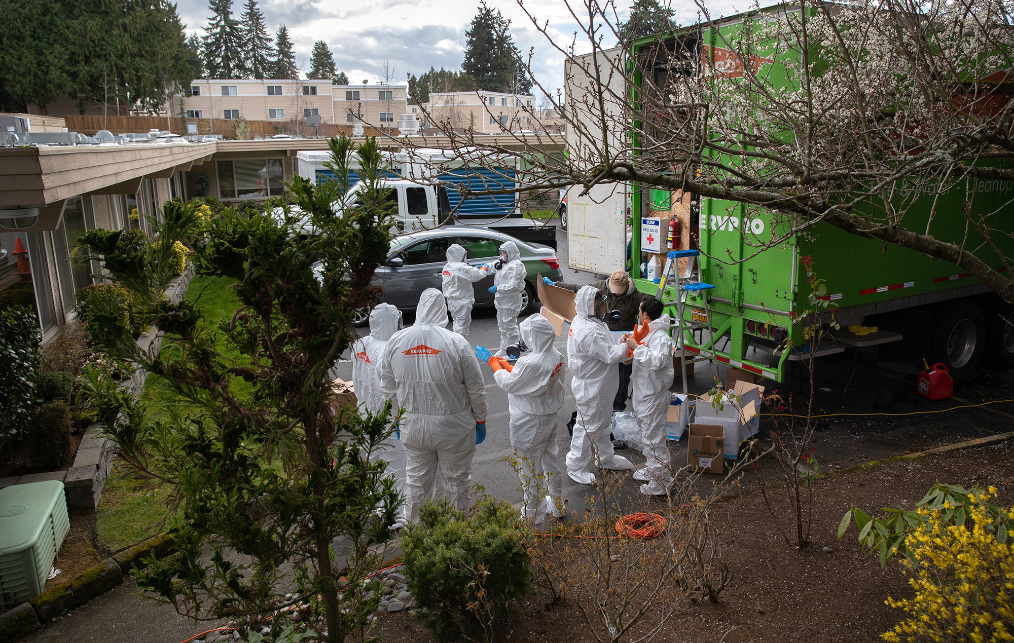 A cleaning crew prepares to enter the Life Care Center in Kirkland, Washington on March 12.