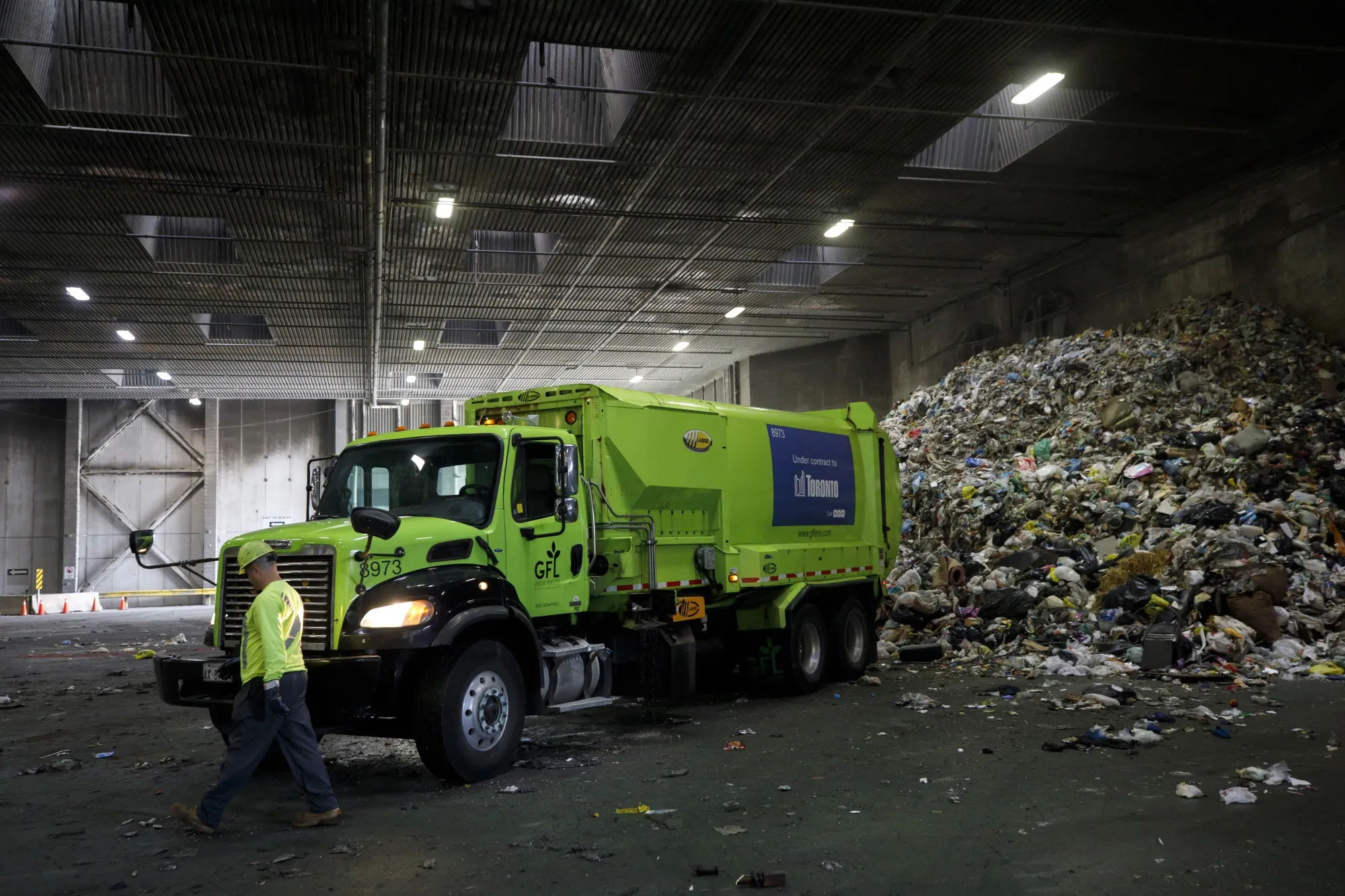 A GFL Environmental Inc. garbage truck prepares to drop off a load of waste at a transfer station in Toronto, Ontario, Canada, on Thursday, Oct. 24, 2019. GFL, North America's fourth-largest waste hauler by revenue, seeks to raise as much as $2.1 billion in what would be the largest initial public offering in Canada since 2004.
