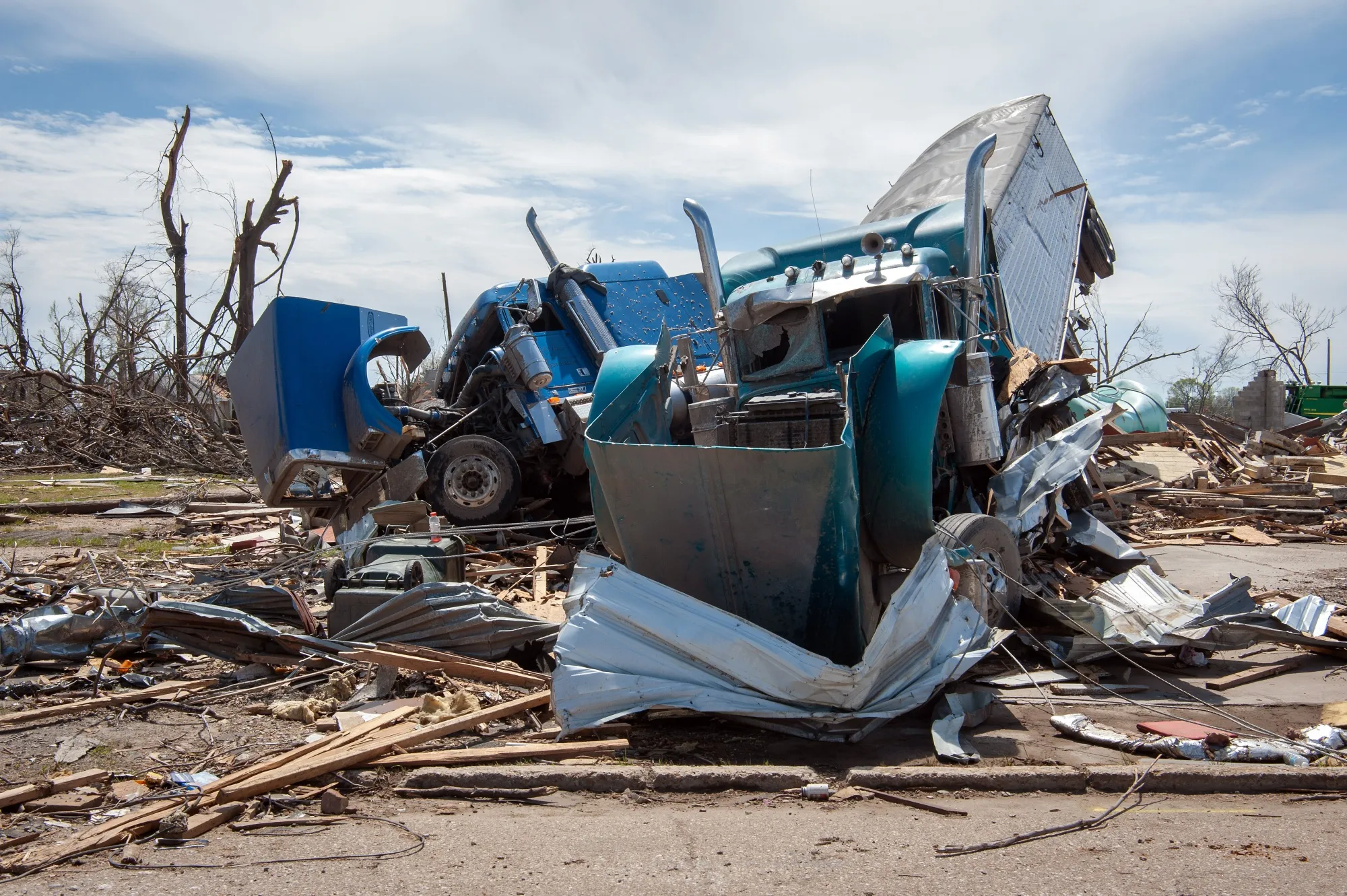 Overturned and damaged trucks following a tornado in Rolling Fork, Mississippi, last year.&nbsp;