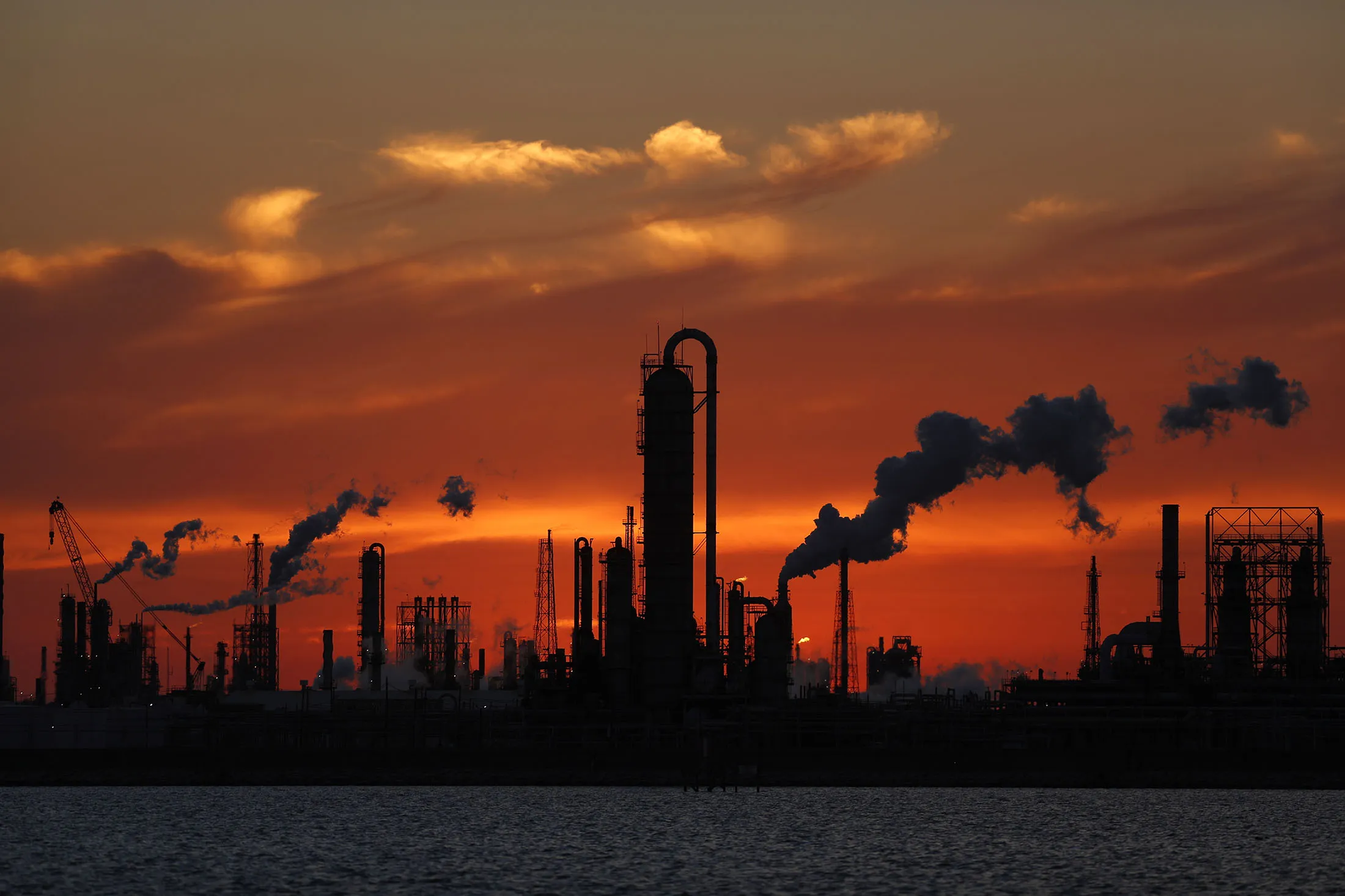 Emissions rise from an oil refinery at sunset in Texas City, Texas, U.S., on Thursday, Feb. 16, 2017. Asia's energy importers will benefit from more opportunities for arbitrage, supply diversification if U.S. President Donald Trump's pro-energy policies drive meaningful upsurge in U.S. crude, LNG exports, BMI Research reports.

