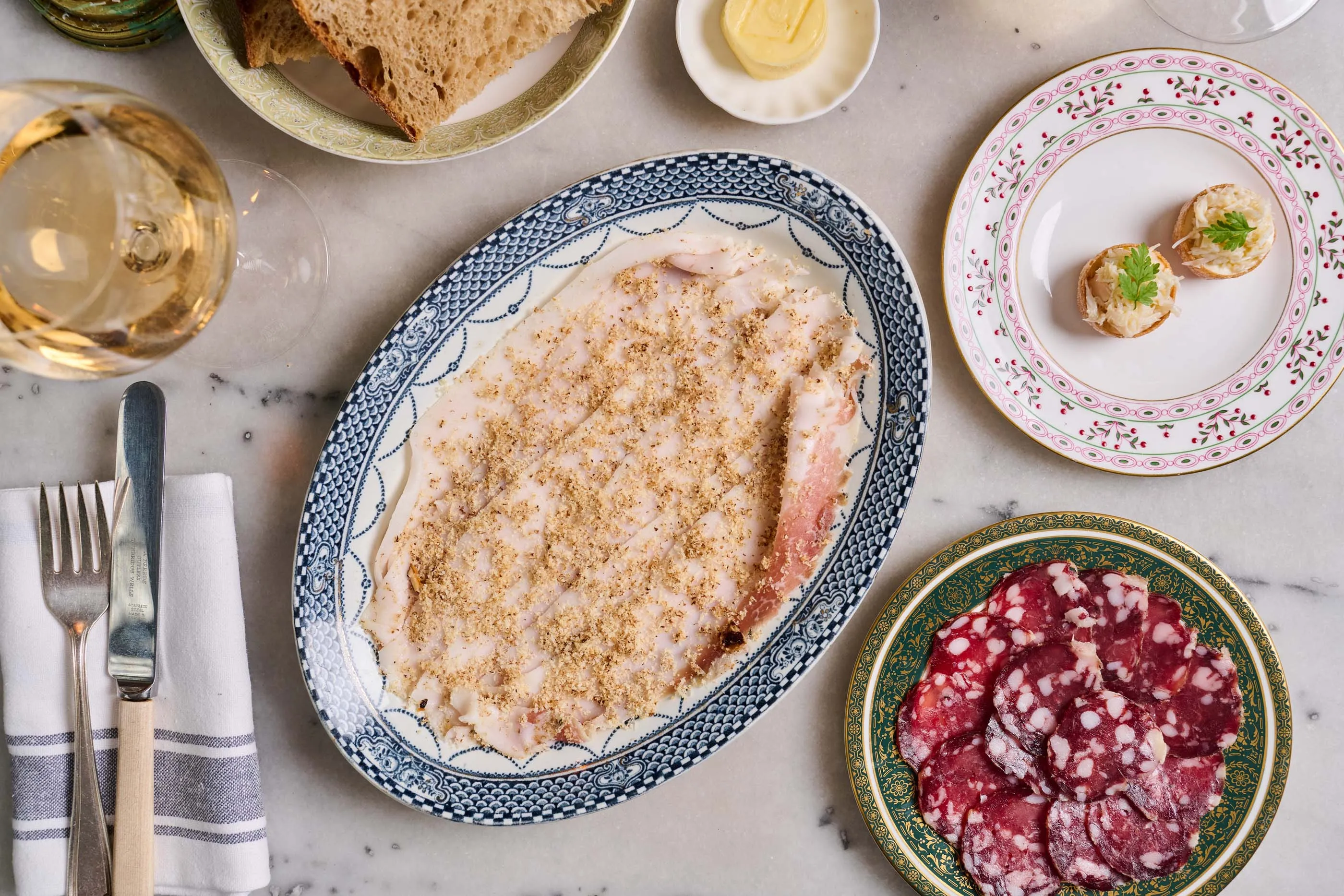 A selection of starters at Cloth: Westcombe&nbsp;salami,&nbsp;lardo and candied walnut and&nbsp;coronation crab tartlets.