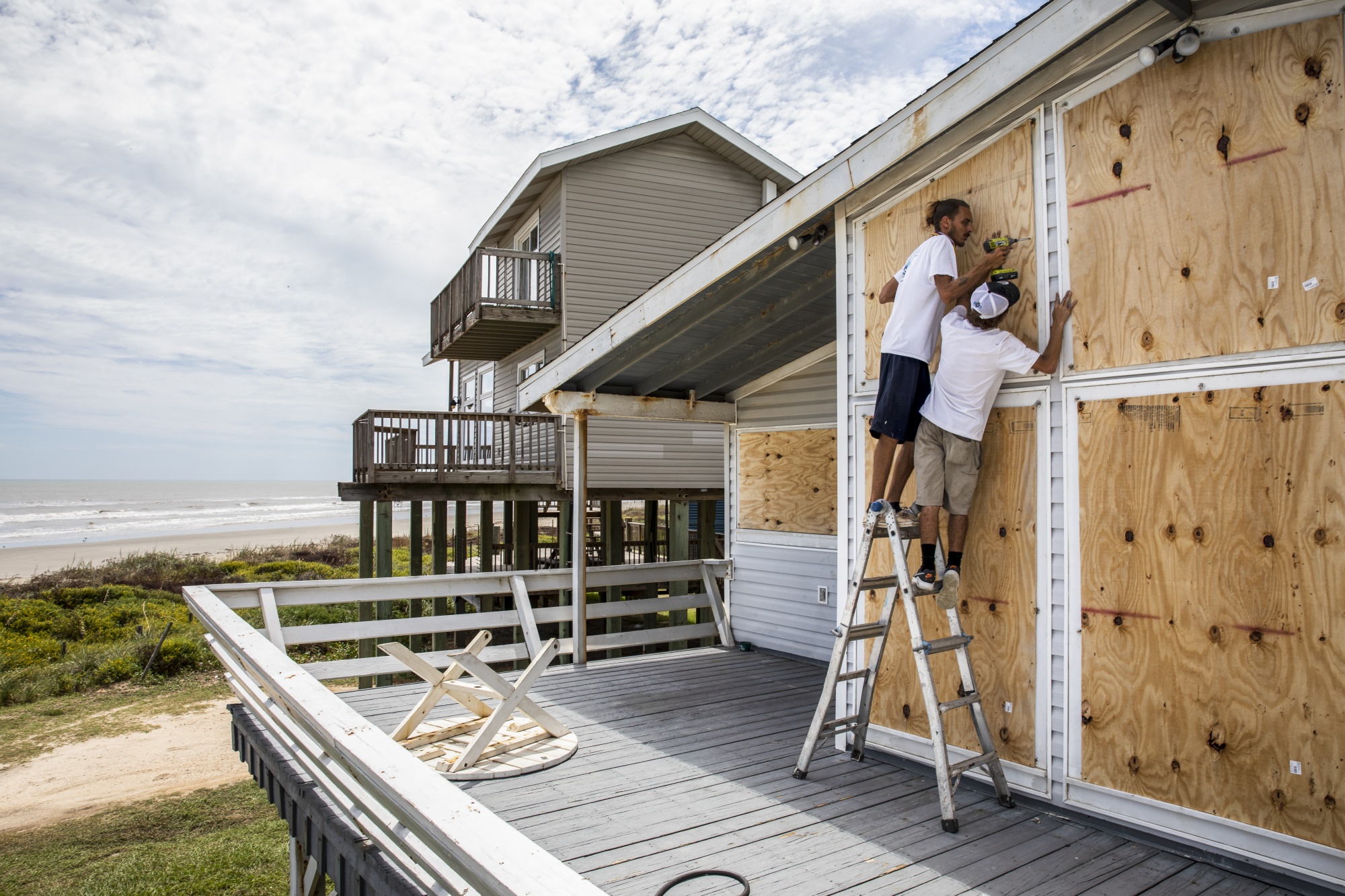 Workers board up a home&nbsp;ahead of Hurricane Laura in Galveston, Texas on Aug. 25.