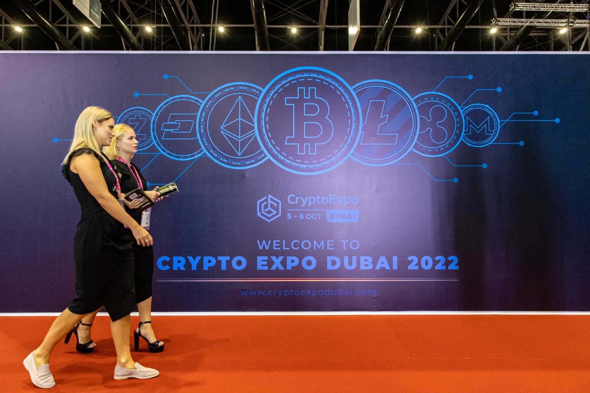 Cryptocurrency logos on an event board during the Dubai Crypto Expo.&nbsp;Photographer: Christopher Pike/Bloomberg
