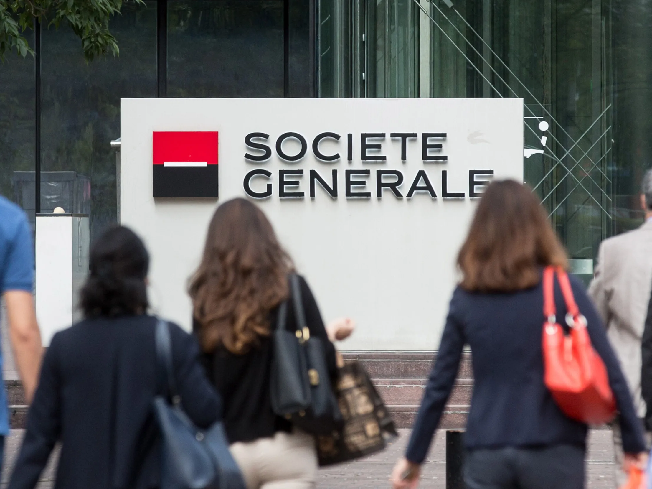 Visitors arrive at the headquarter offices of Societe Generale SA in the La Defense business district in Paris, France.