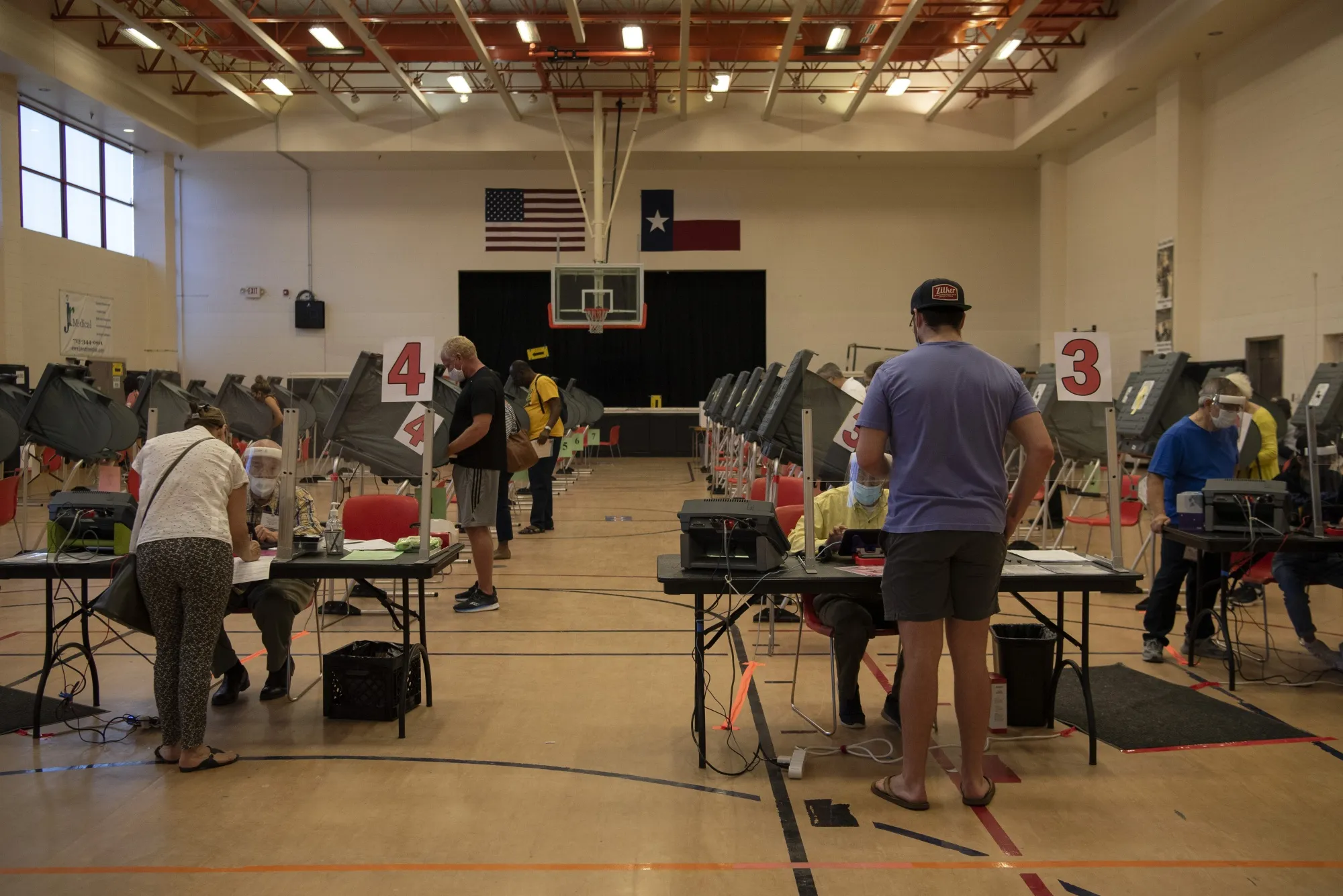 Election workers assist voters at an early voting polling location in Houston, Texas, on Oct. 13.