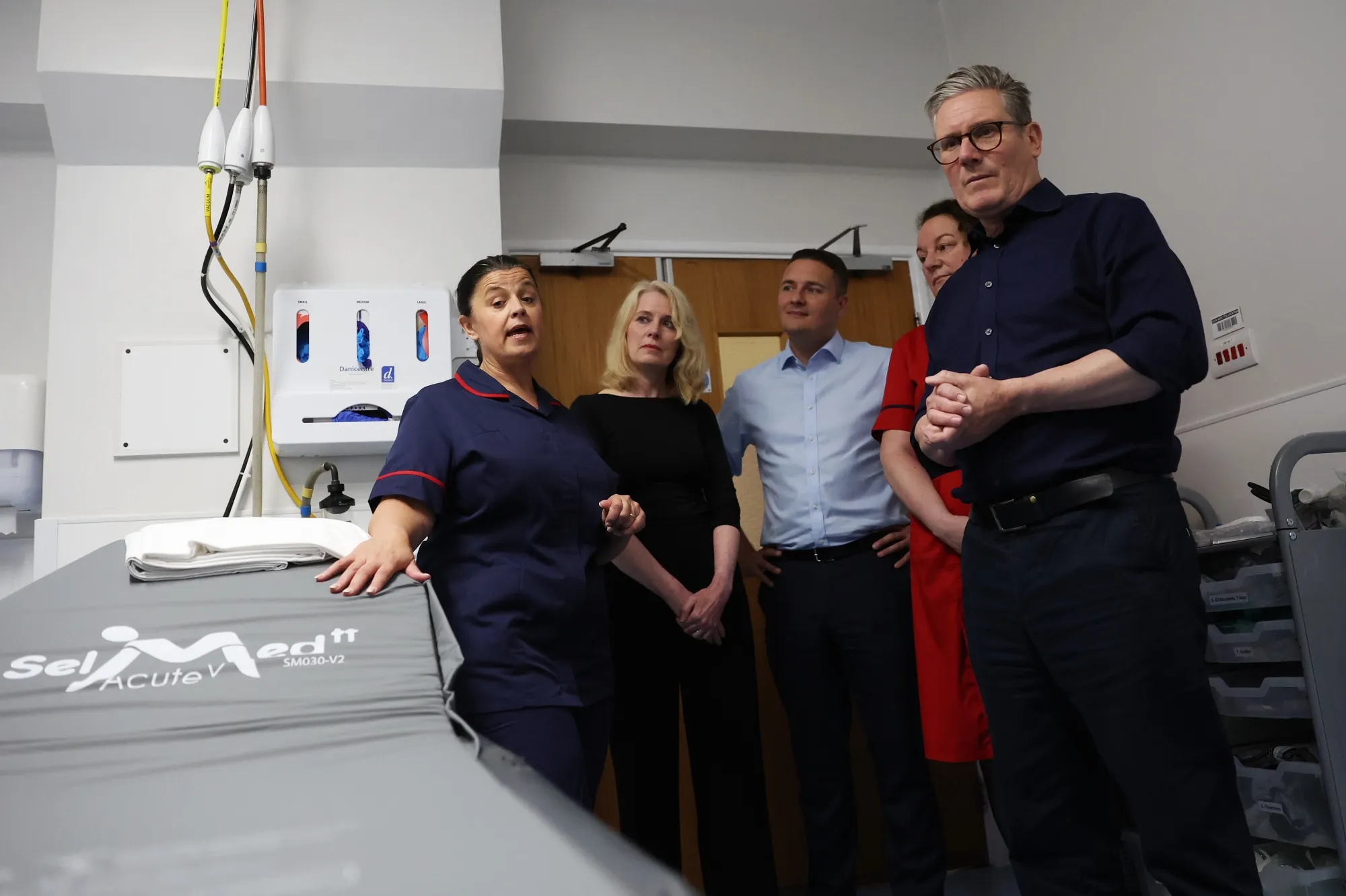 Keir Starmer, right, and Wes Streeting, center, meet staff as they visit Bassetlaw Hospital in Worksop, UK, on June 15.