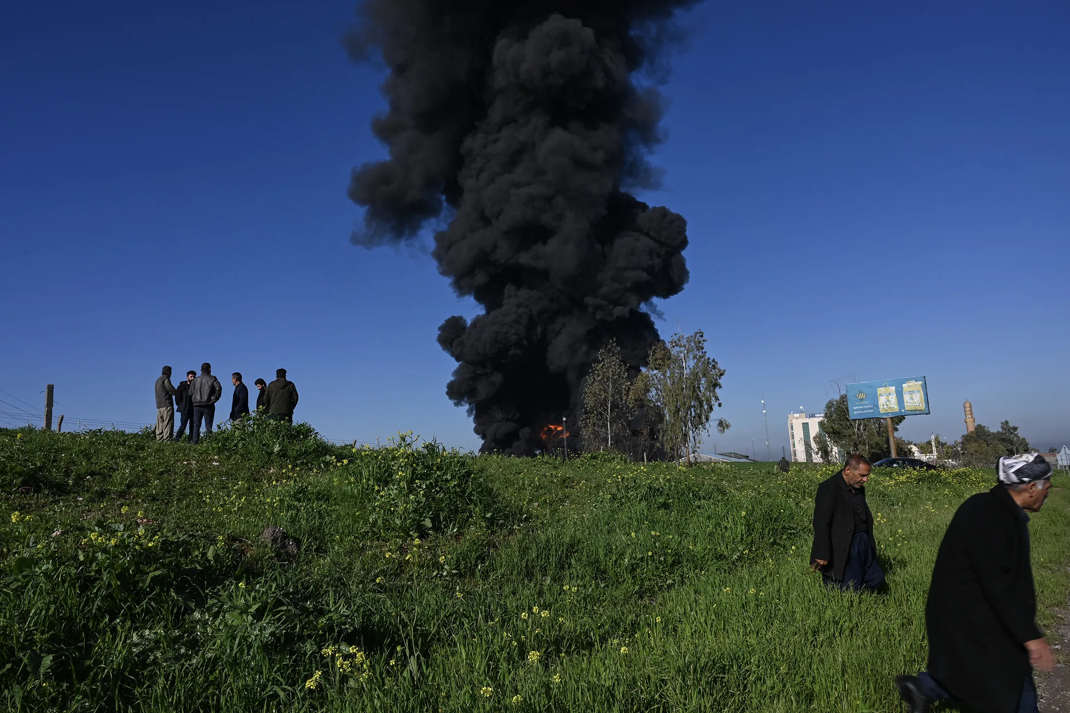 Smoke billows from an oil warehouse in the Kani Qirzhala area on the outskirts of Erbil, the capital of Iraq's autonomous Kurdistan region, following a suspected drone strike, on April 1.