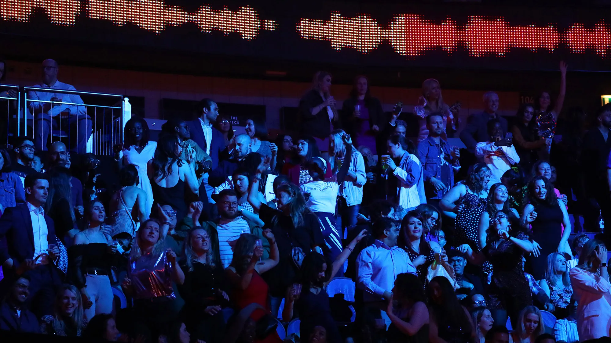 Fans watch The BRIT Awards at The O2 Arena in London on May 11.