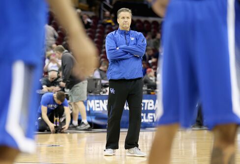 John Calipari the head coach of the Kentucky Wildcats watches his team practice.