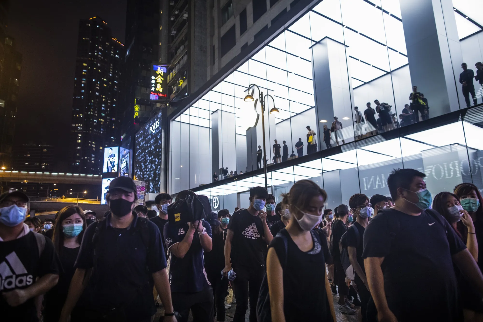 Demonstrators walk past an Apple&nbsp;store on Canton Road during a protest in Hong Kong on July 7, 2019.&nbsp;