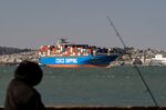 A China Ocean Shipping Group Co. ship waits to enter the Port of Oakland in Oakland, California, U.S.