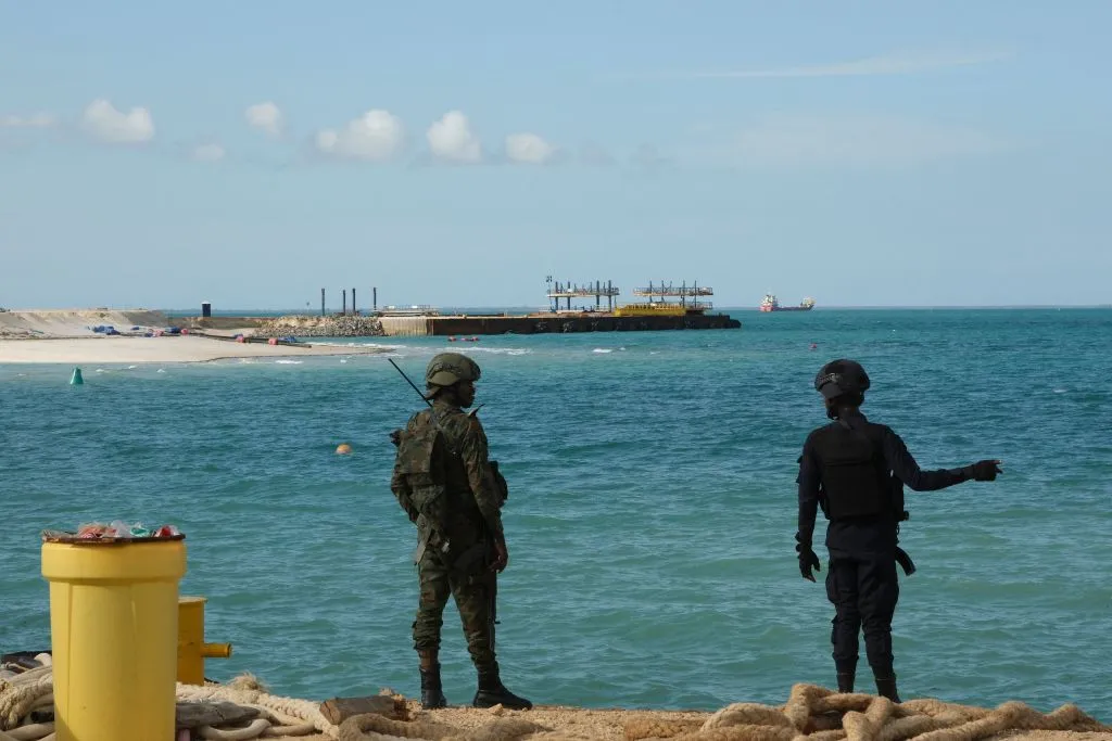 A Rwandan policeman and a Rwandan soldier guard The Total Mozambique LNG Project in Afungi in the Cabo Delgado province, Mozambique.