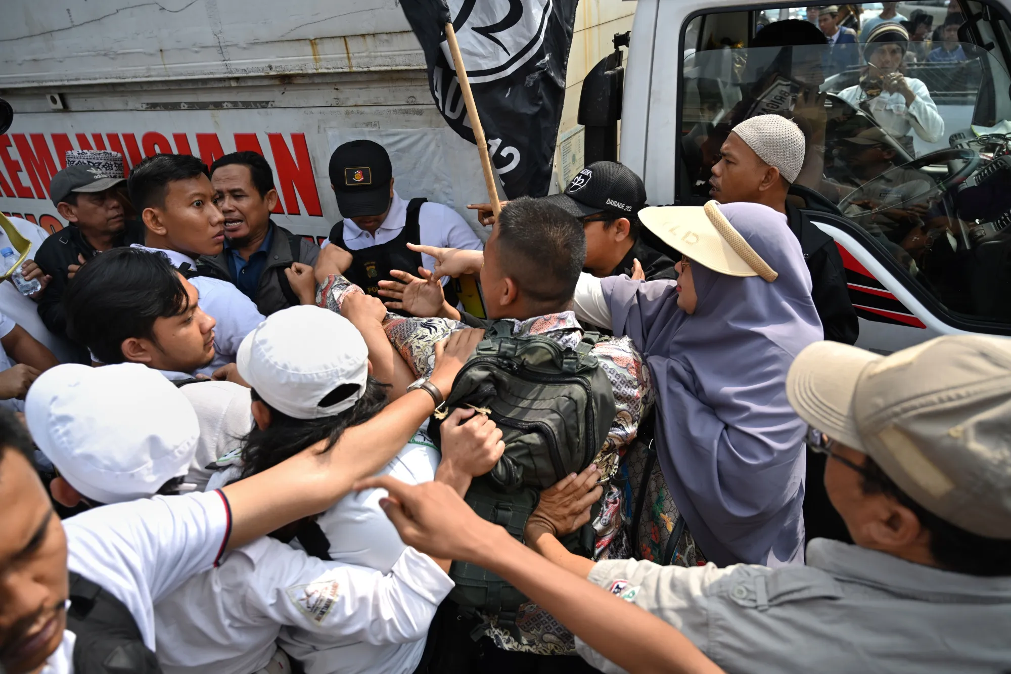 Protesters argue with plain-clothed police during a rally near the constitutional court in Jakarta on June 26.
