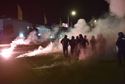 Right-wing demonstrators clash with police as they protest against a refugees camp in Heidenau, Germany.