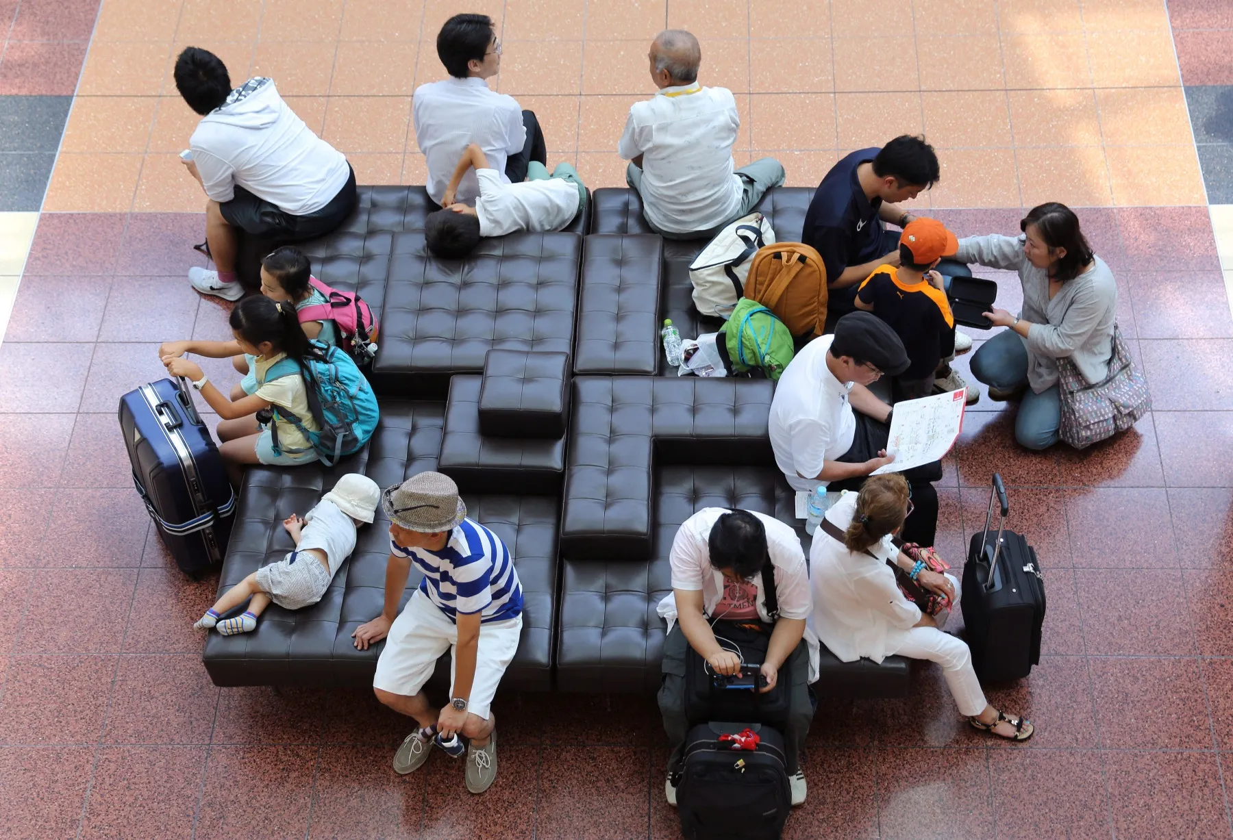Airline passengers wait for their flights.