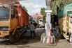 Drivers refuel their trucks in Indonesia.