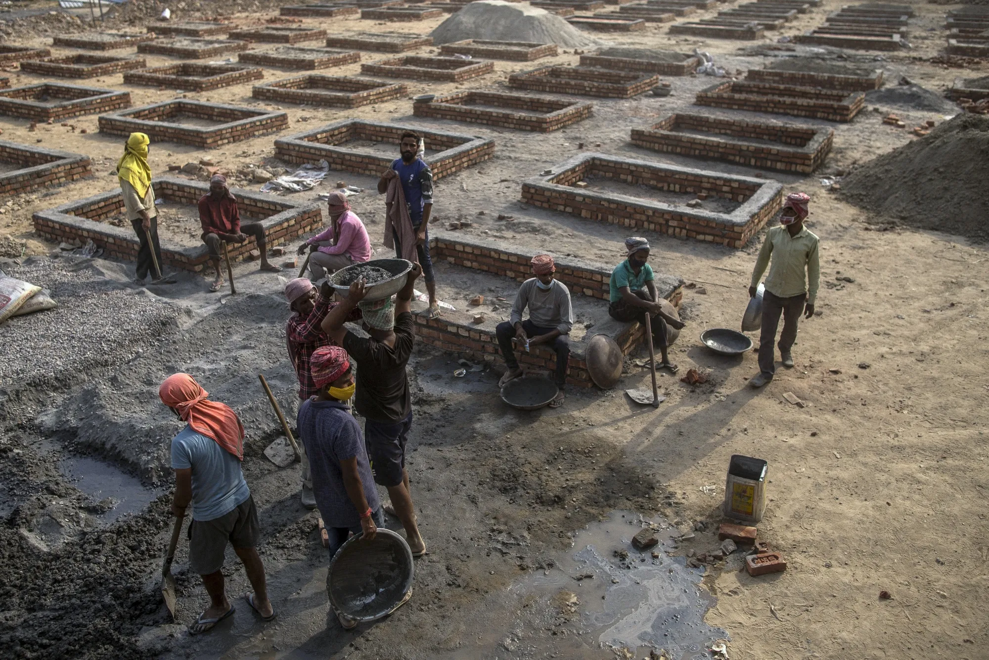 Workers construct funeral pyre plinths on barren land near a crematorium in New Delhi&nbsp;on April 30.